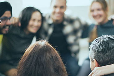 Group of wrok colleagues gathered together in a circle