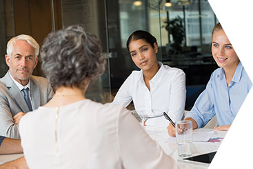 Executives sitting at boardroom meeting