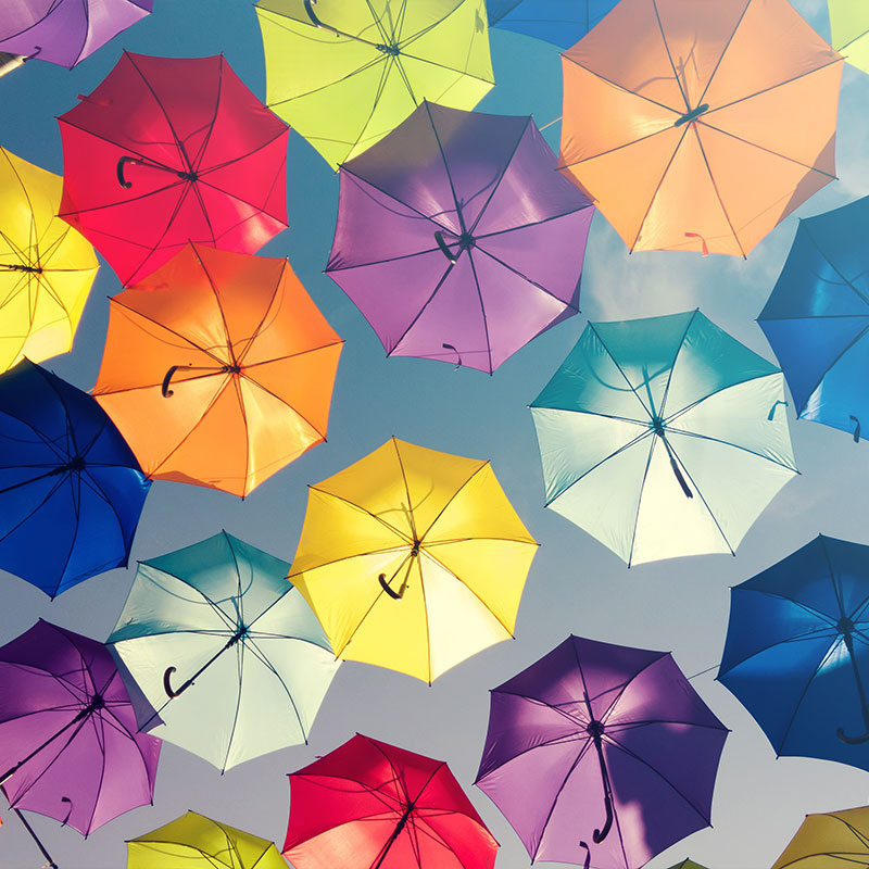 Lots of different colour umbrellas symbolising diversity