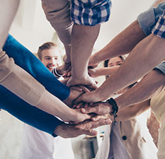 Employees with hands together as a team