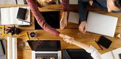 Closeup of people working on a desk