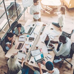 Multicultural employees working together at desk