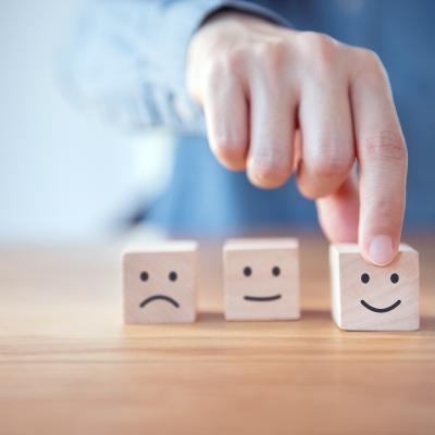 Hand moving wooden blocks with smiley face