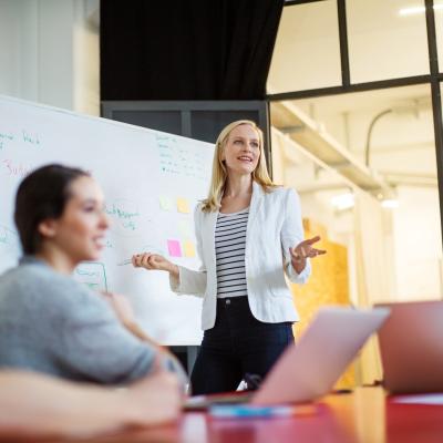 Woman presenting to small workshop