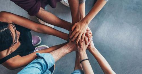 People with hands together