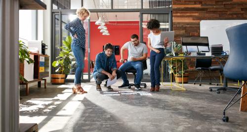 Workers discussing a challenge together