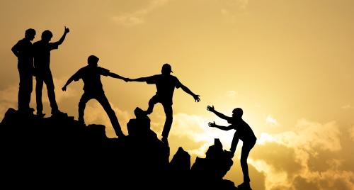 People helping each other on mountain