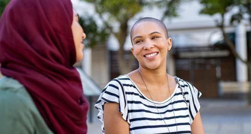 2 ladies smiling at each other