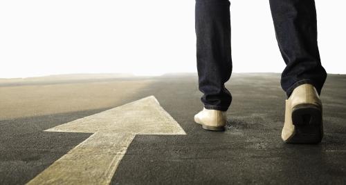 Closeup of man walking on road