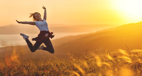 Lady jumping at sunset