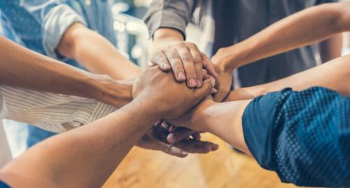 Office team holding hands in circle