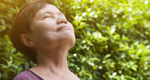 Woman breating in deeply outside