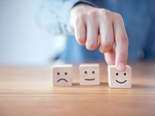 Hand moving wooden blocks with smiley face