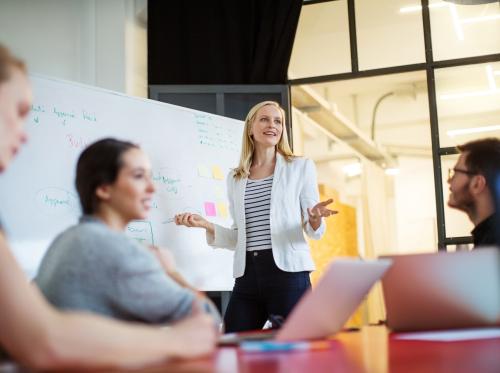 Woman presenting to small workshop