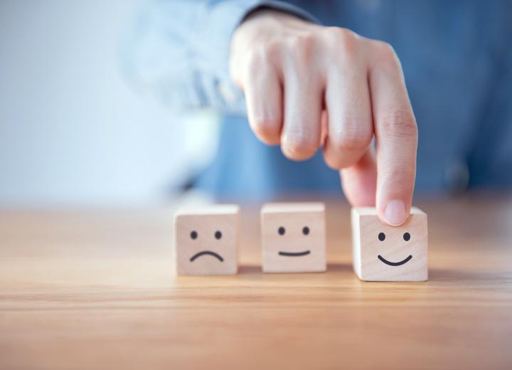 Hand moving wooden blocks with smiley face