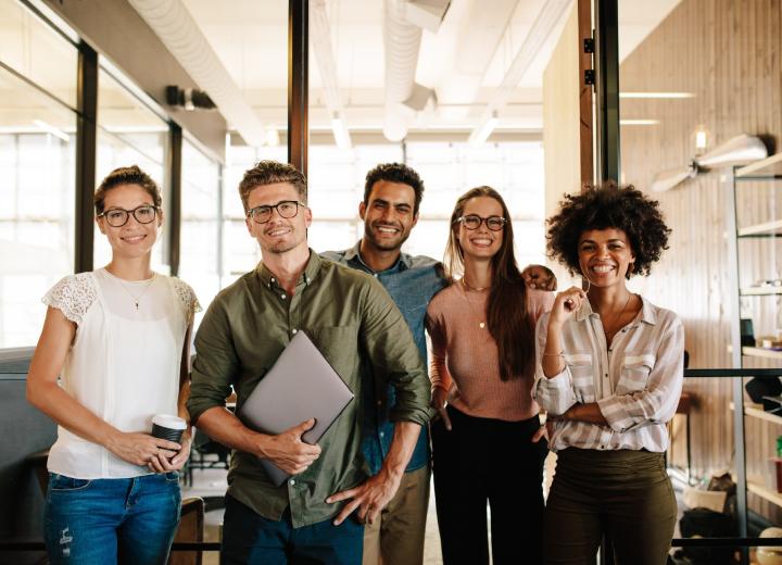 Smiling team members standing side by side