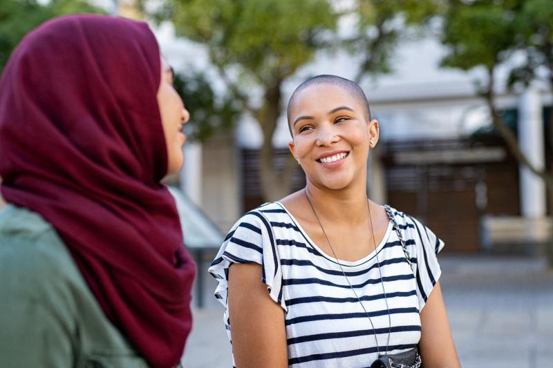 2 ladies smiling at each other