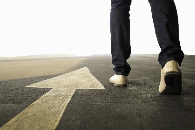 Closeup of man walking on road