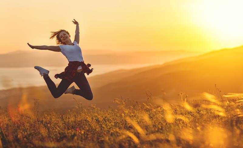 Lady jumping at sunset