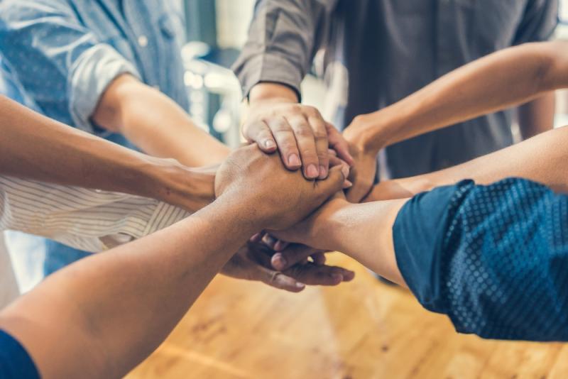 Office team holding hands in circle